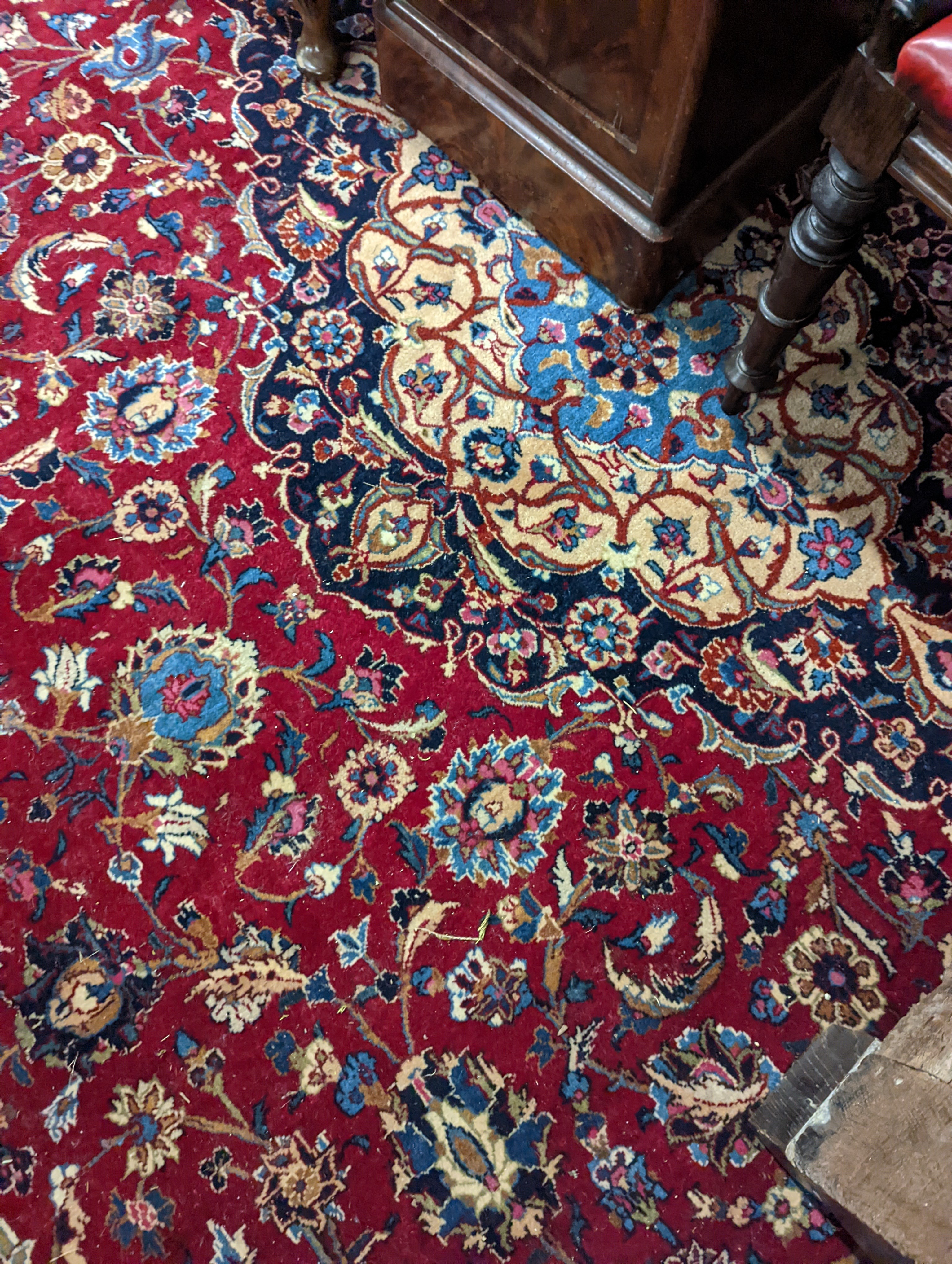 A Kashan burgundy ground carpet, 380 x 300cm